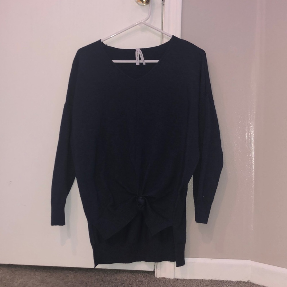 dark blue or navy long sleeve tee shirt with twist knot at the bottom